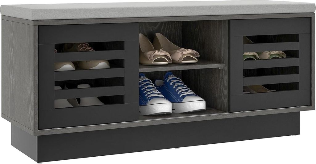 A shoe bench with storage compartments and a cushioned top, displaying shoes inside.