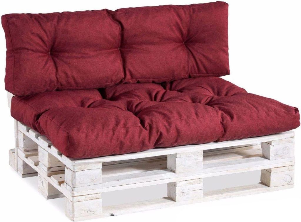 A burgundy pallet sofa cushion set on a white wooden pallet.