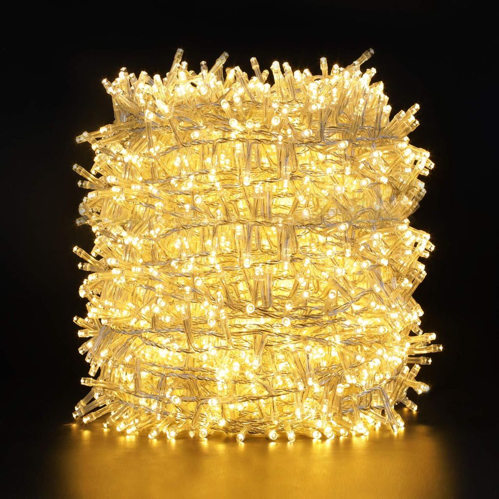 A tightly wound coil of warm white LED string lights against a black background.
