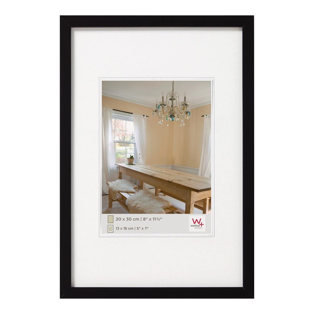 A framed picture of a dining room with a long wooden table and chandelier.