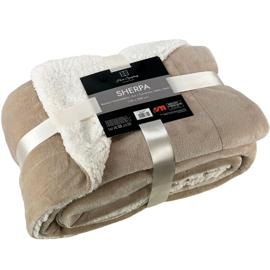 A folded beige sherpa blanket with a cream-colored sherpa lining, tied with a ribbon and a product tag.