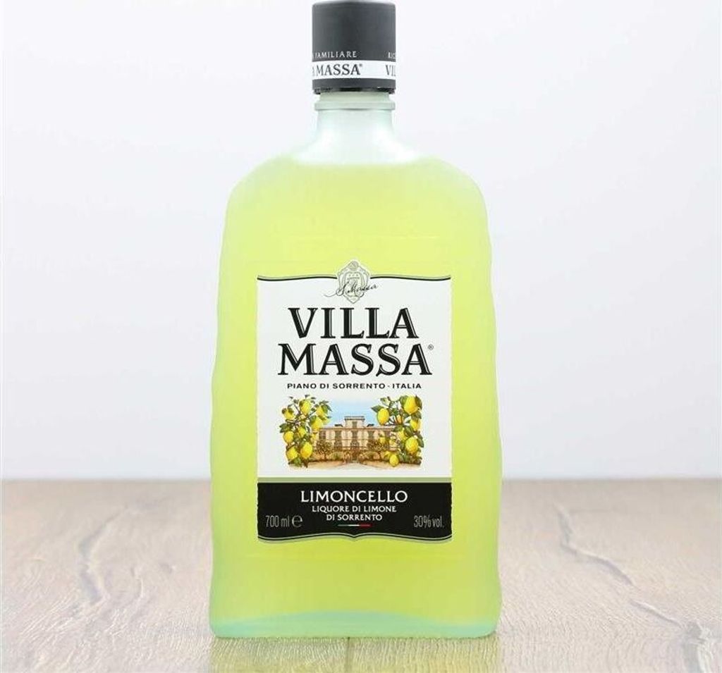 A bottle of Limoncello Villa Massa on a wooden surface.