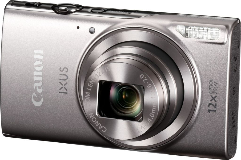 A silver Canon IXUS compact camera is shown from a diagonal front view against a white background.