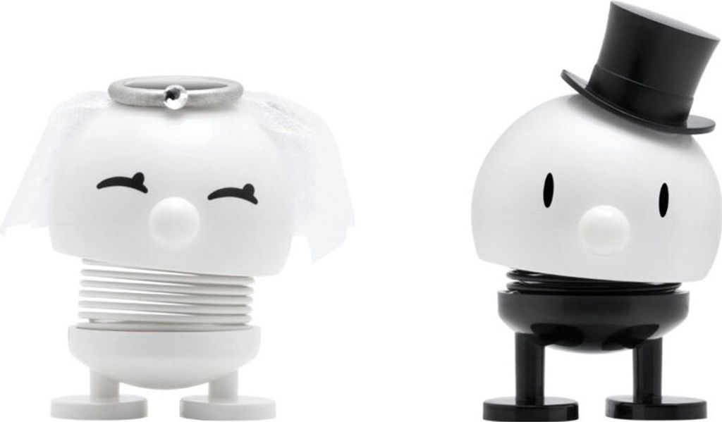 Two spring-loaded figurines, one representing a bride and the other a groom, are displayed against a white background.