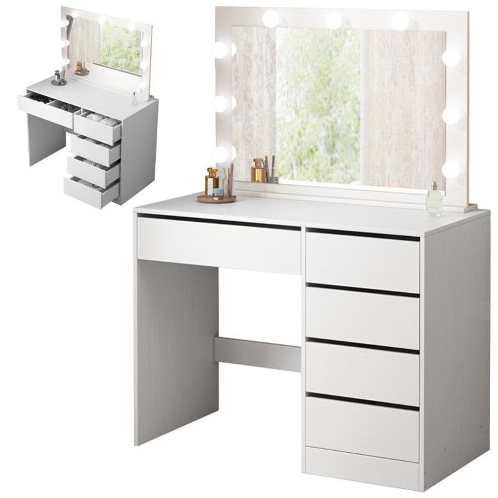 A white vanity table with a lighted mirror and drawers.