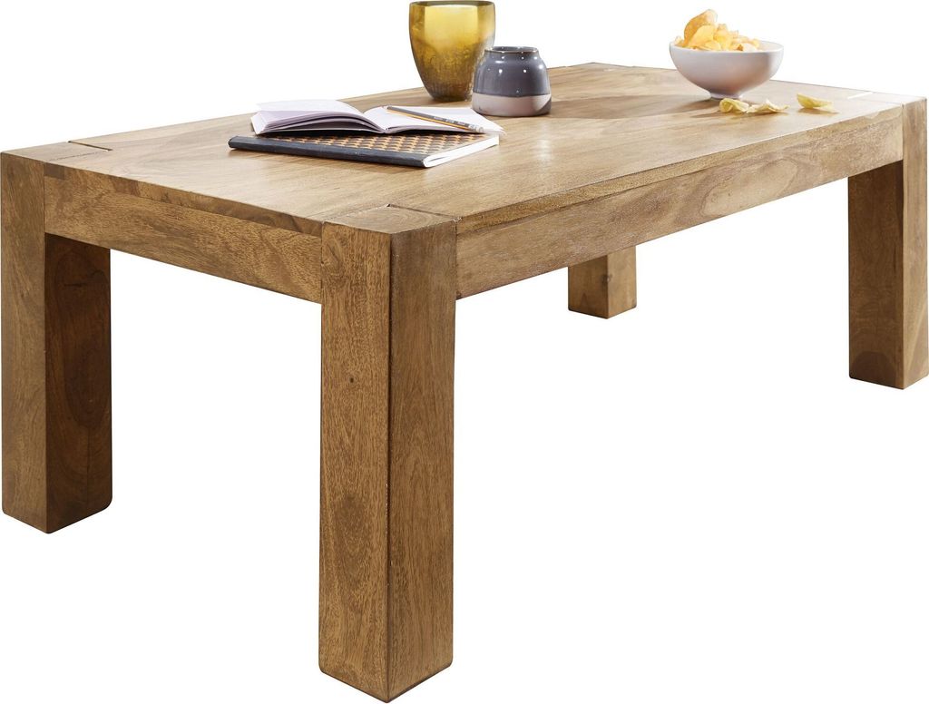 A wooden coffee table with decorative items on top.