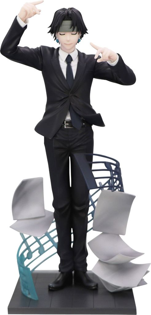 A figurine of a character from Hunter x Hunter in a suit, with musical notes and papers as a base.