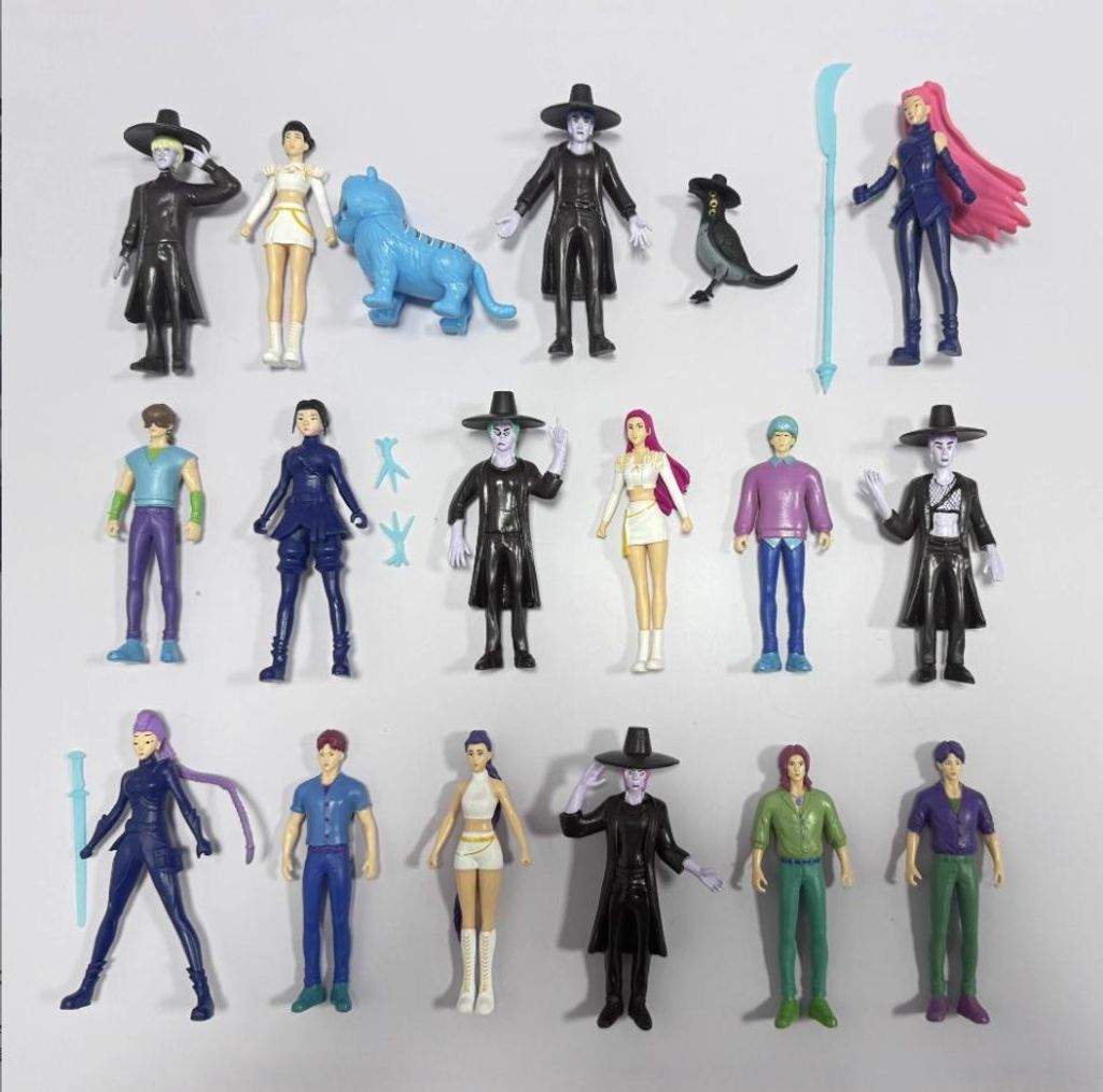 A collection of anime-style action figures arranged on a light gray background.