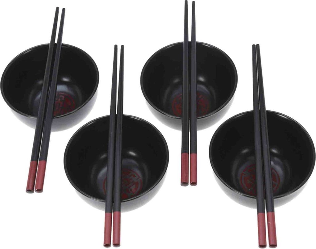 Four black ceramic bowls with chopsticks on a white background.