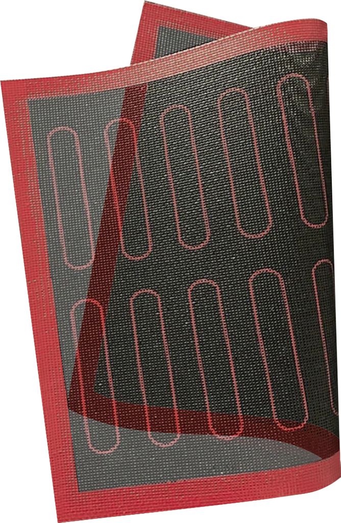 A baking mat with oval indentations for making cookies.