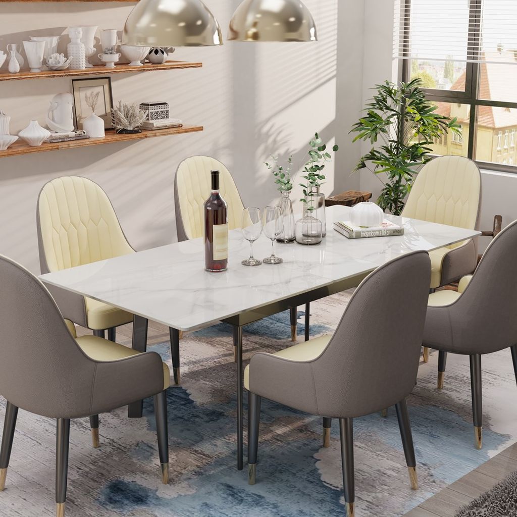 A dining room scene with a marble-look table and chairs, set for a meal.