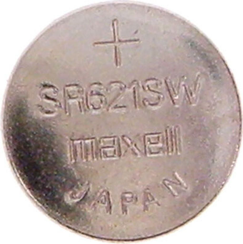 A close-up view of a silver coin-shaped battery.