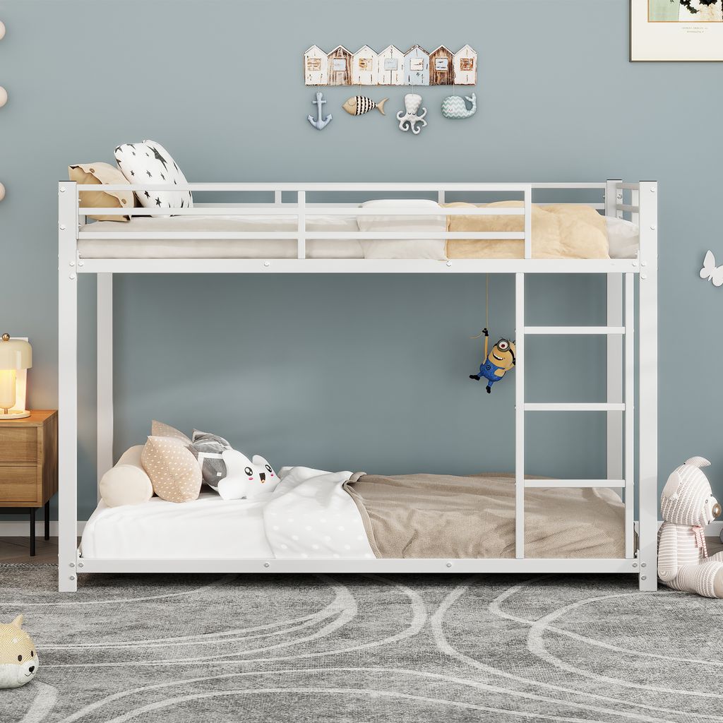 A white metal bunk bed in a child's room with decorative items on the wall and stuffed animals on the beds.