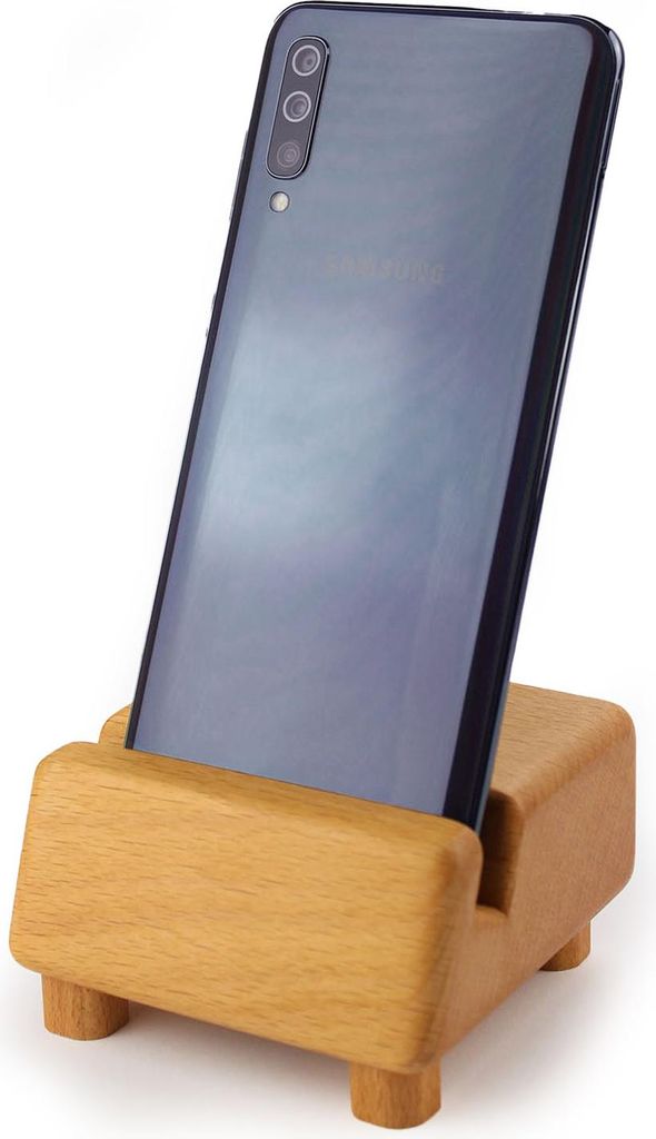 A smartphone is placed in a wooden stand against a white background.