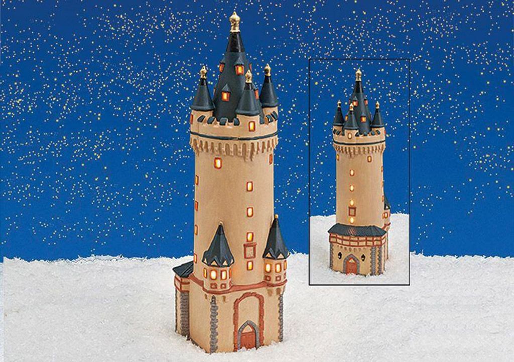 A miniature replica of the Eschenheimer Turm in Frankfurt, Germany, displayed in a snowy, winter-themed setting with a starry blue background.