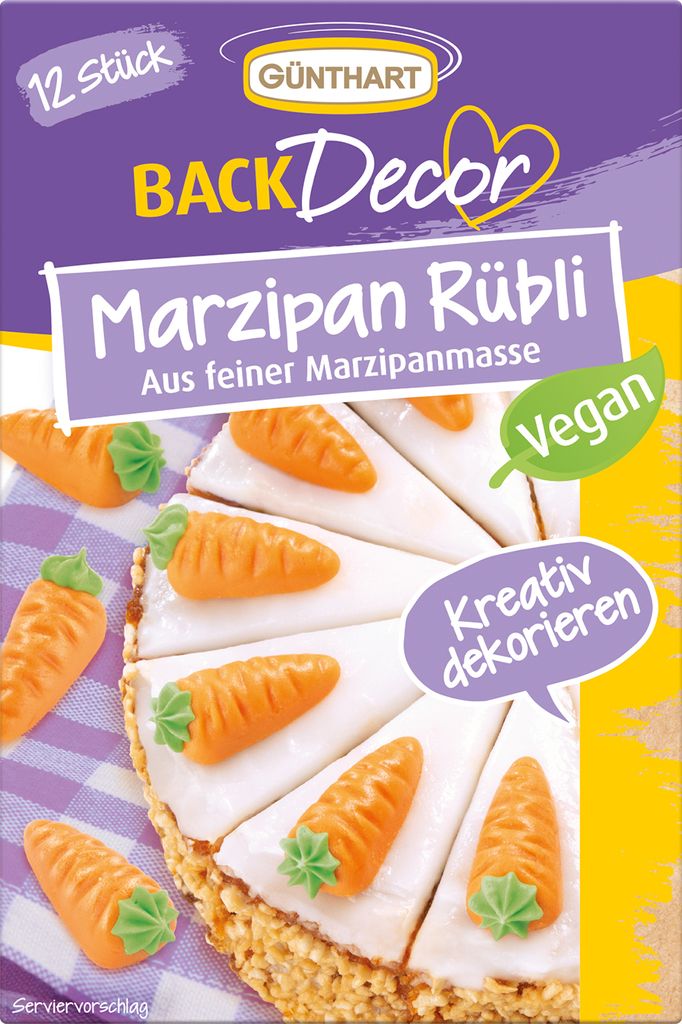 A package of marzipan carrot decorations on a cake.