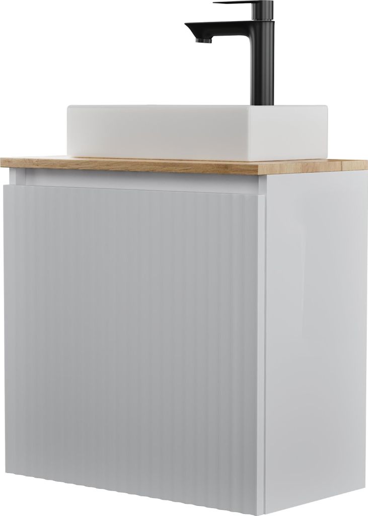 A white bathroom vanity with a rectangular sink and a black faucet on a wooden countertop.