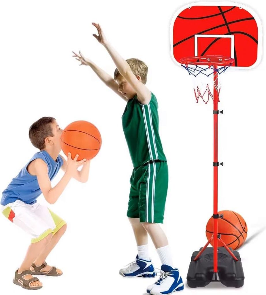 Two children playing basketball with a portable basketball hoop.