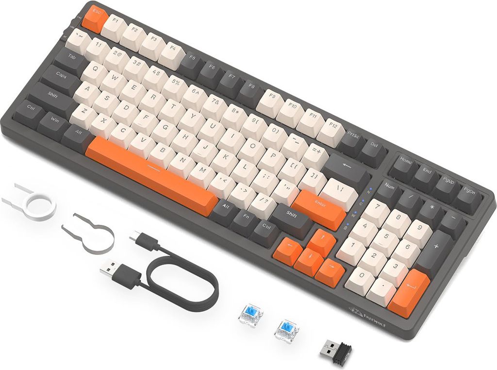 A mechanical keyboard with various accessories laid out next to it on a white background.