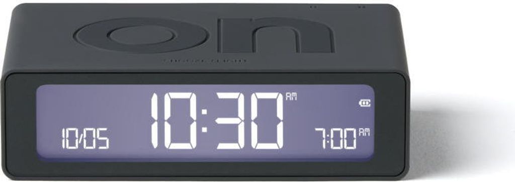 A dark gray digital alarm clock with a digital display showing the time.