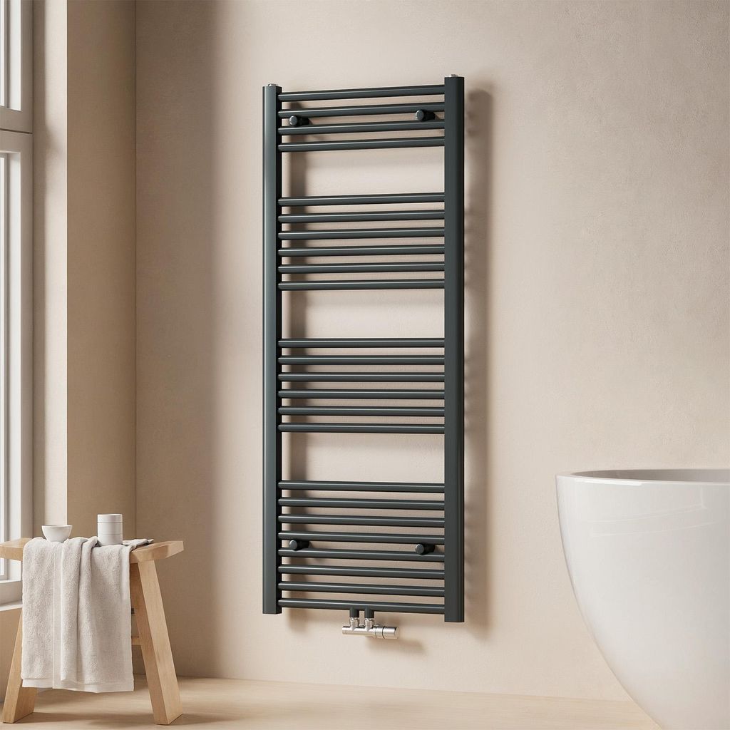 A modern bathroom with a towel radiator, a stool with a towel, and a bathtub.