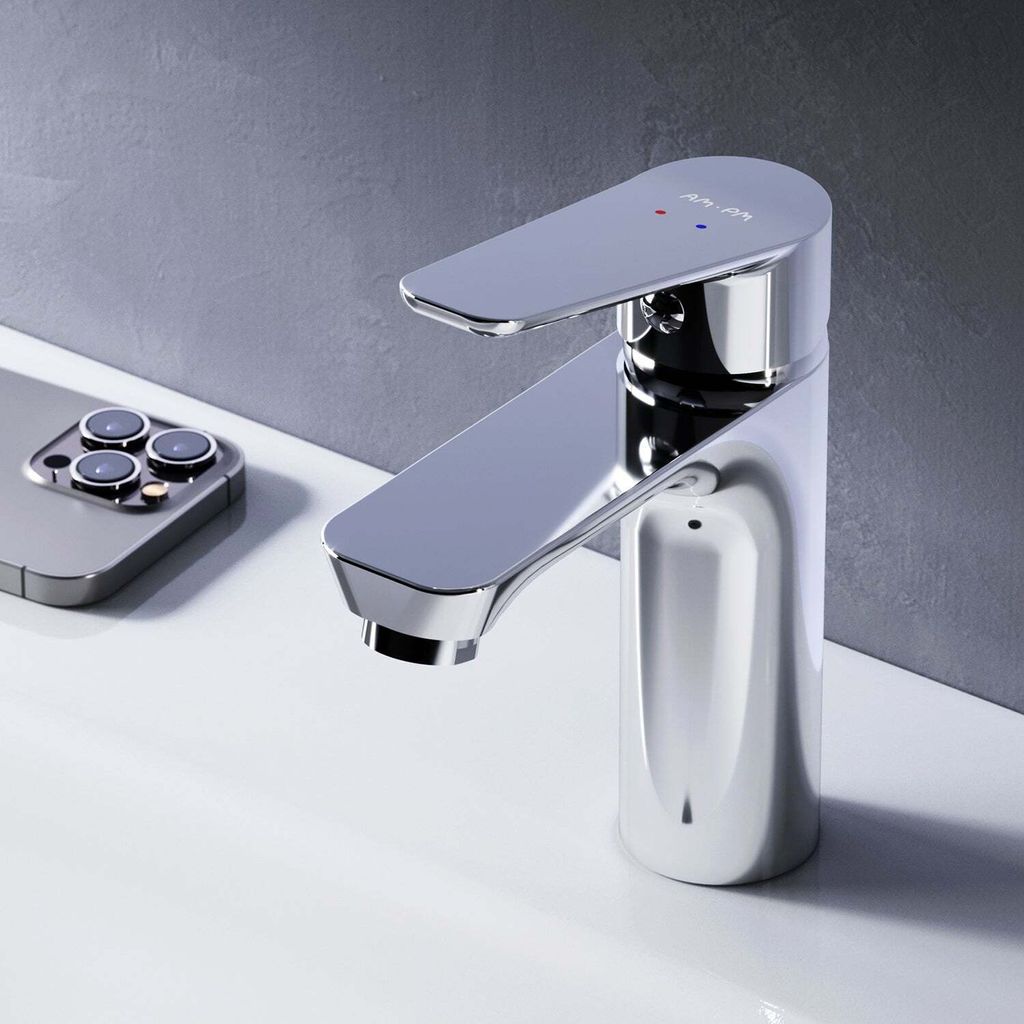 A chrome faucet is shown on a white sink, with a smartphone in the background.