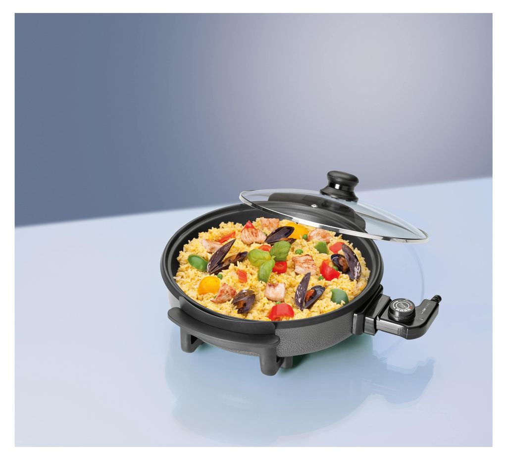 A close-up shot of an electric multi-function pan filled with paella, placed on a light blue surface with a gradient blue background.