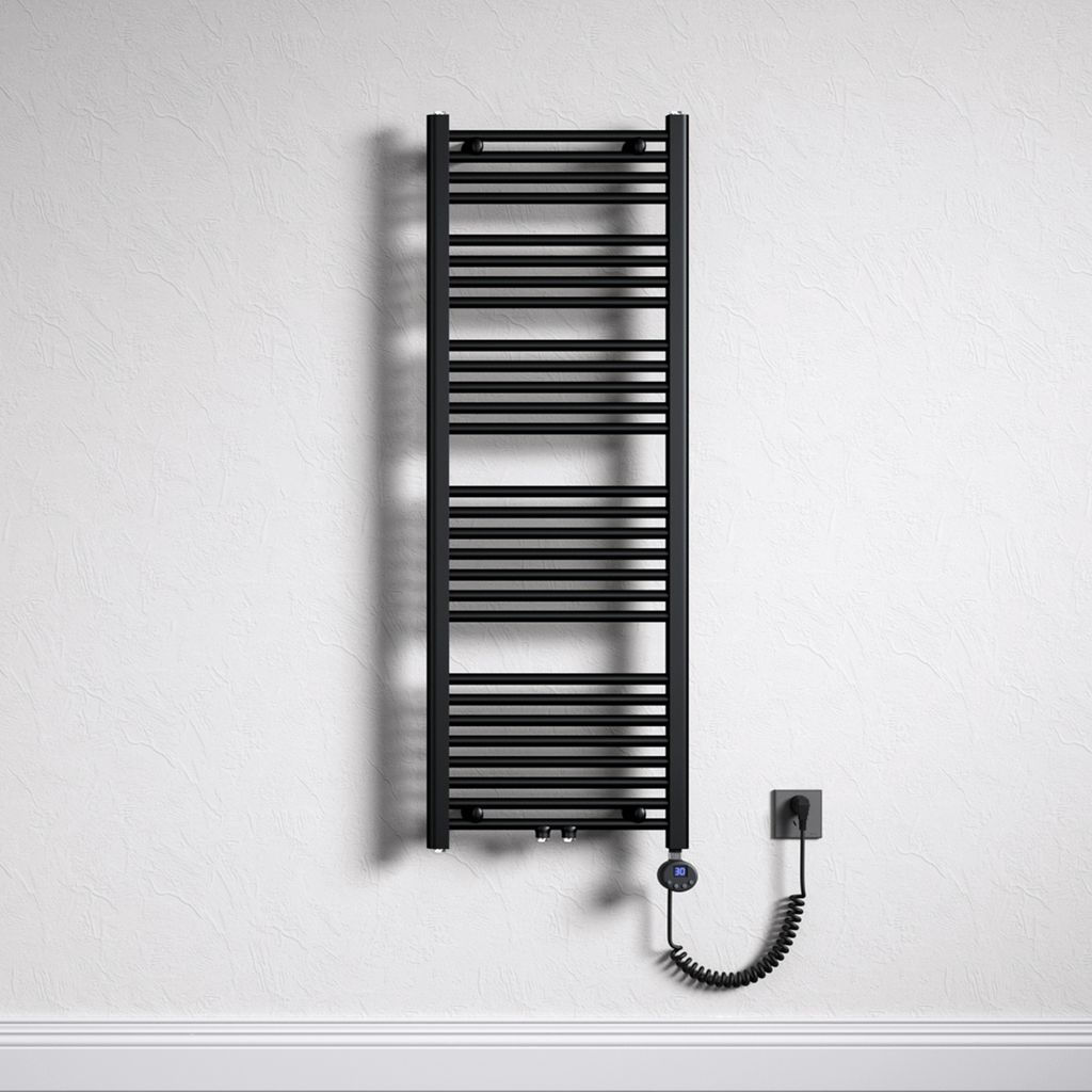 A black electric towel radiator mounted on a textured white wall, with a coiled power cord connecting to a wall socket.