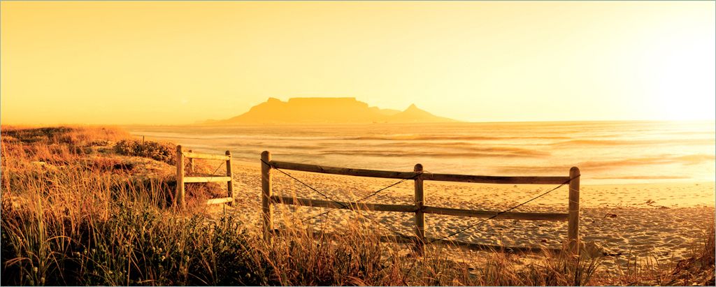 Wallario Poster - Strand in Südafrika I - Himmel in orange, Kunstdruck Größe: 50 x 125 cm