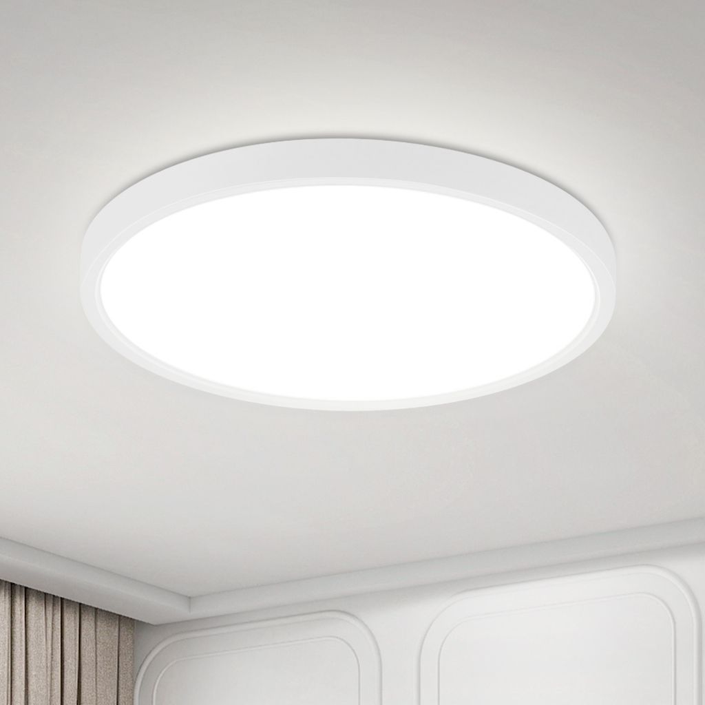 A white, circular LED ceiling light is mounted on a white ceiling.