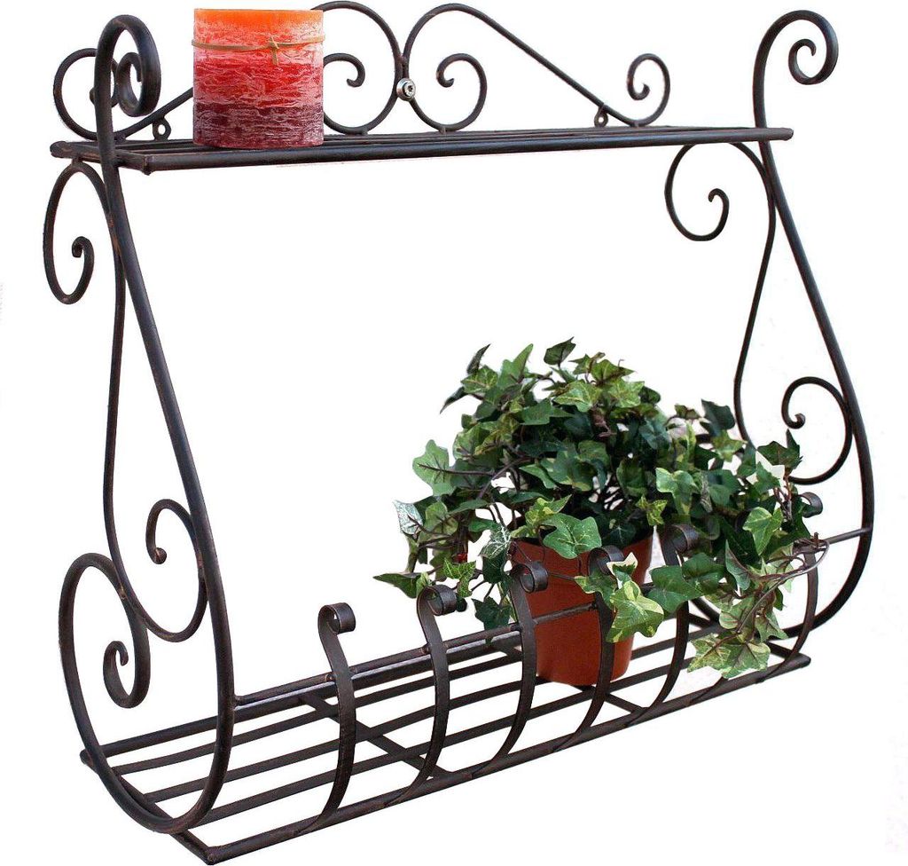 A black metal wall shelf with a candle and a potted plant.