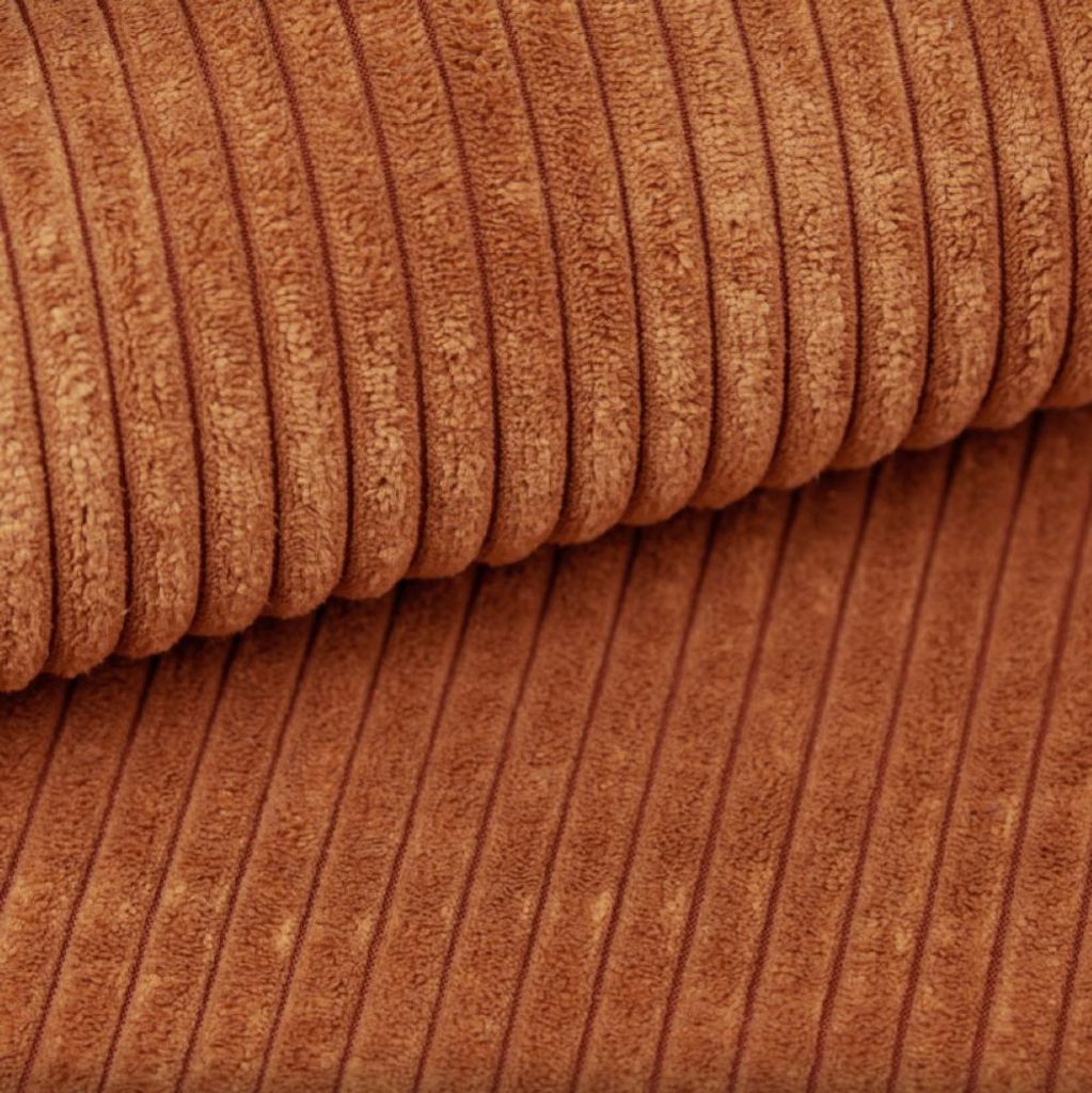 A close-up view of brown corduroy fabric.