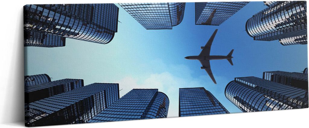 Flugzeug über Gebäuden – Leinwandbild Wandbild – 125x50 cm – Leinwandbilder – Wandbilder – Schlafzimmer – Flur