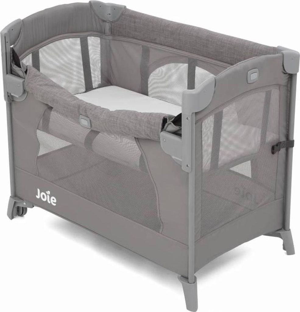 A grey Joie Kubbie Sleep travel cot is shown from a slightly elevated side angle against a white background.