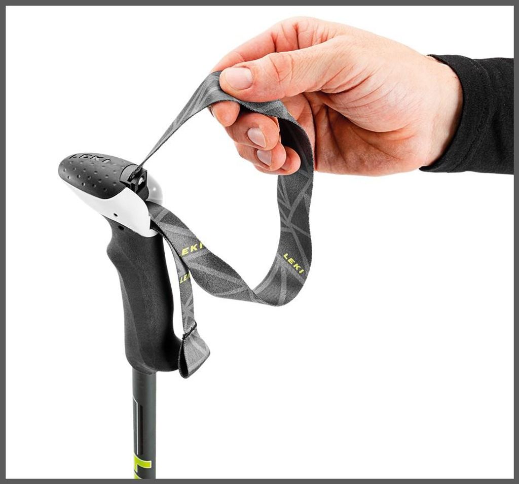 A hand holding a strap attached to a trekking pole handle.