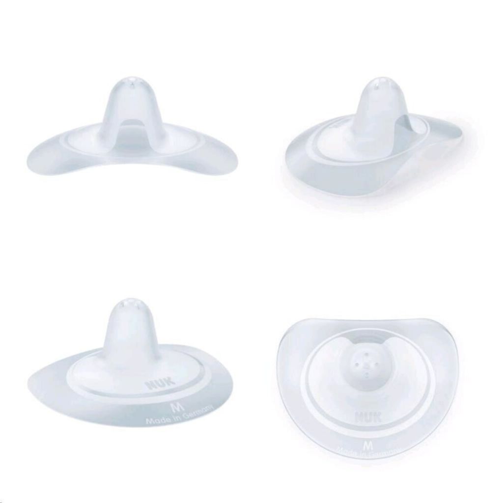 Four views of NUK breast shells on a white background.