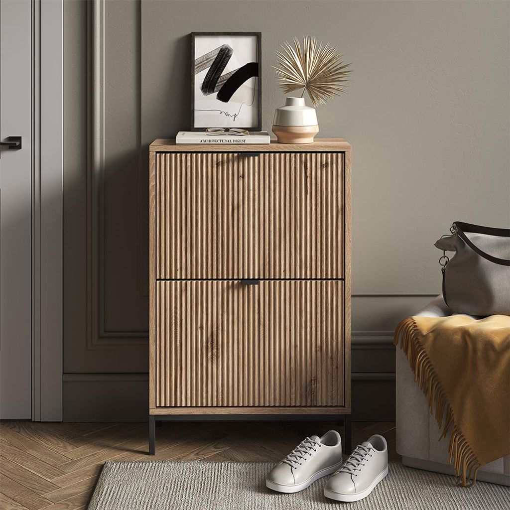 A hallway or entryway scene featuring a wooden shoe cabinet, shoes, and a bag.