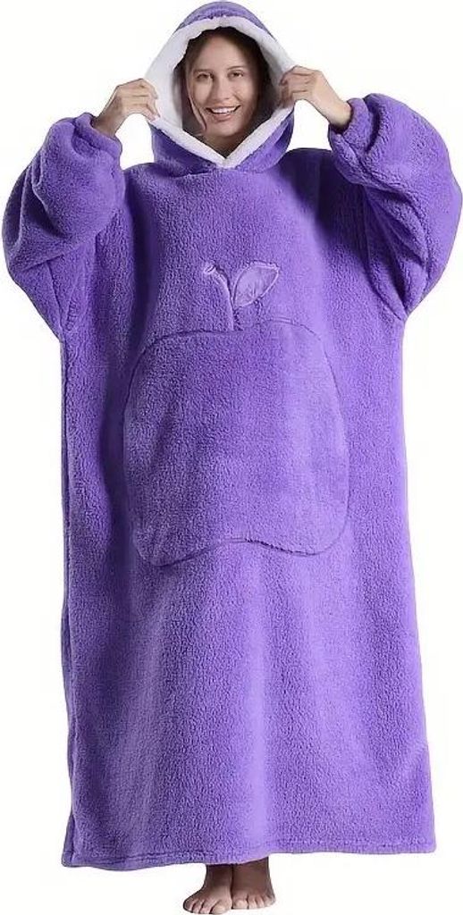 A woman wearing a purple oversized hoodie blanket.