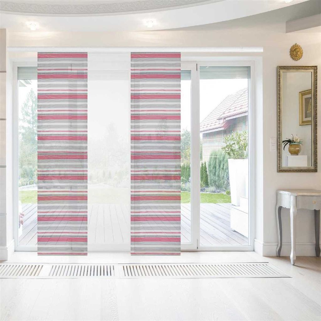 A room with a large sliding glass door covered by panel blinds. The blinds have a striped pattern in light gray and raspberry colors. The room has white flooring and a white console table with a mirror above it.