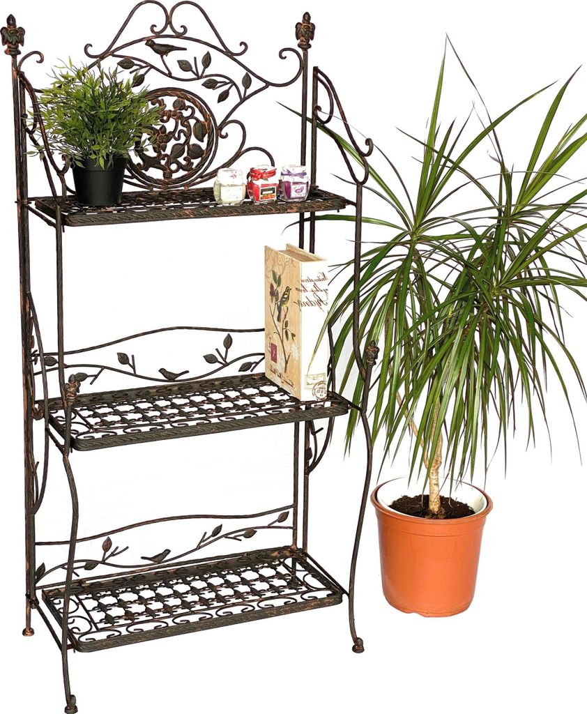 A metal shelf unit with plants and jars on it, next to a potted plant.