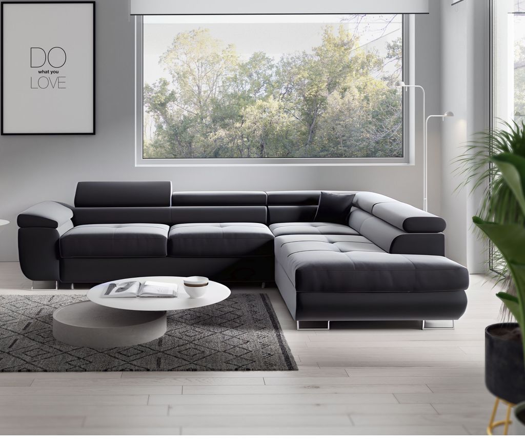 A modern living room with a large sectional sofa, coffee table, and a framed picture on the wall.
