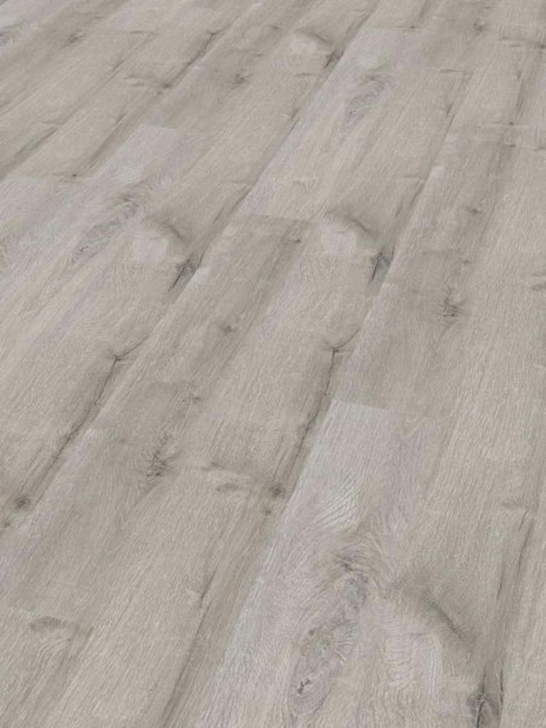 A close-up, angled view of a light gray wood-look vinyl floor.