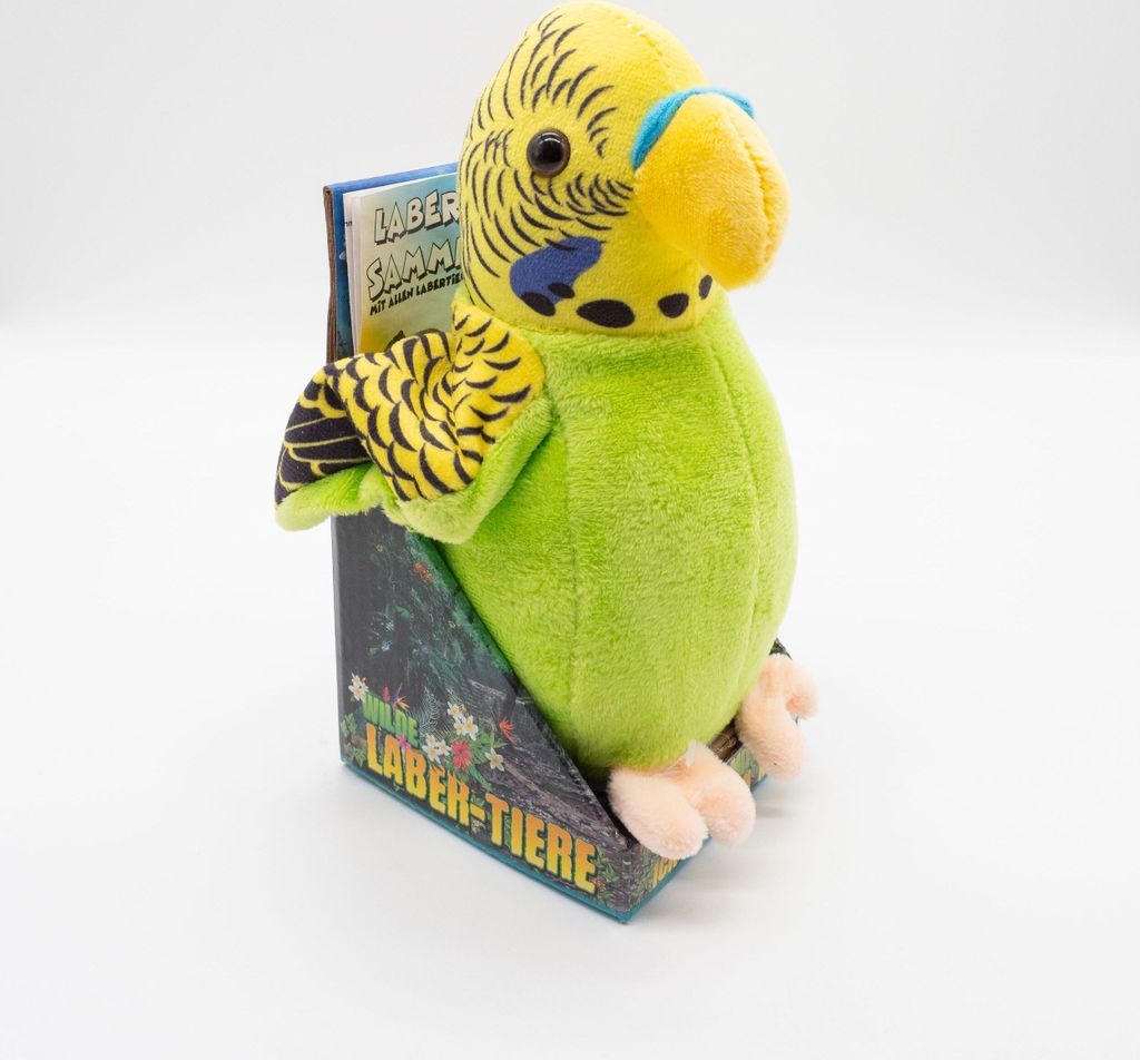 A plush toy budgie in its packaging, presented against a white background.