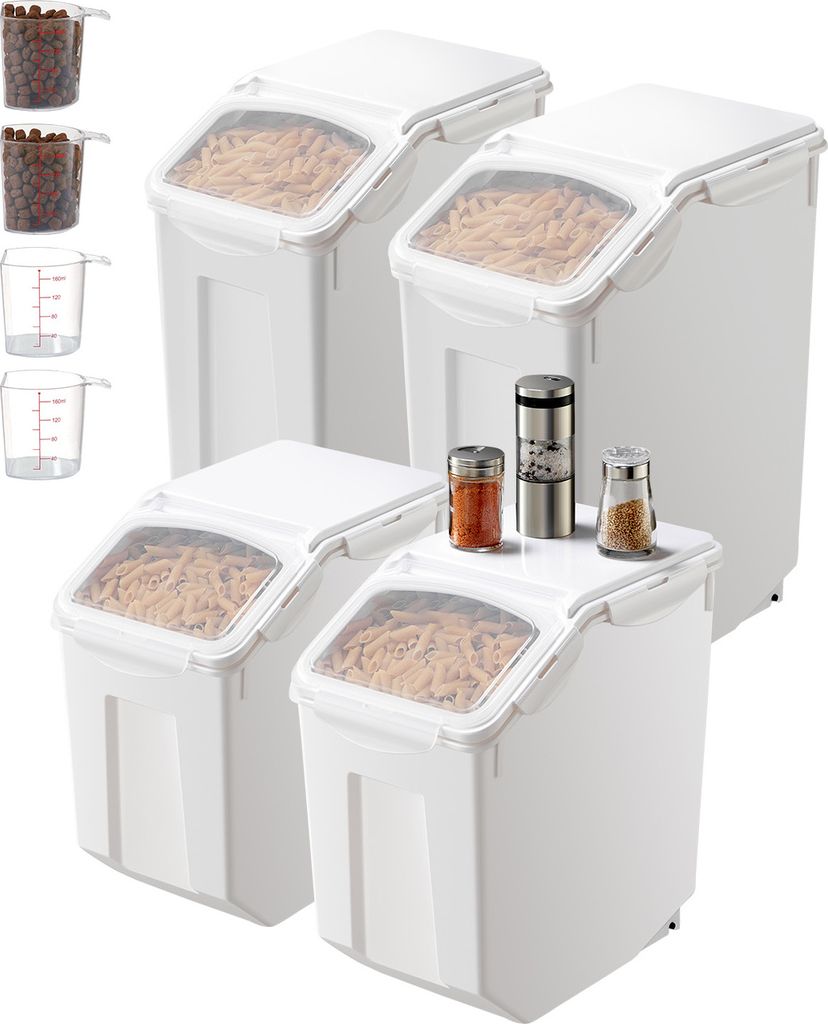 A set of white food storage containers with clear lids, some filled with pasta, and small spice grinders and shakers on top of one container.