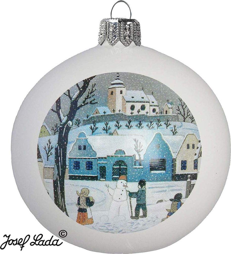 A white Christmas ornament with a painted winter village scene, including houses, a church, a snowman, and children playing.