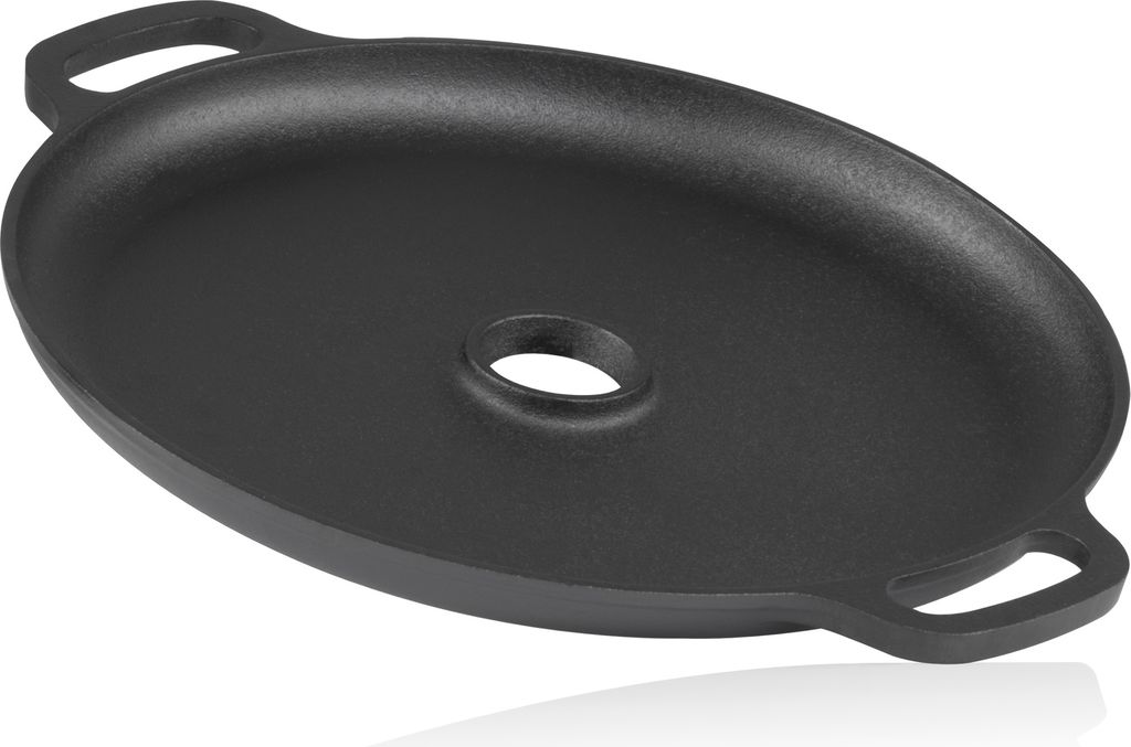 A black cast iron griddle with handles and a central hole.