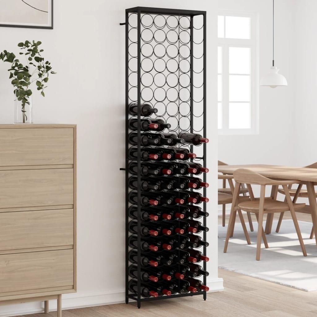 A tall, black wine rack filled with wine bottles stands next to a light-colored dresser in a room with wooden furniture and a window in the background.