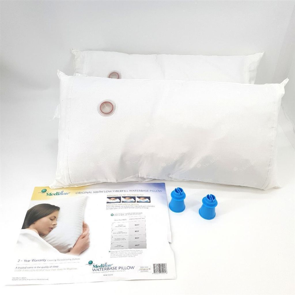Two white pillows are shown on a white background, with a product information sheet and two blue caps in the foreground.