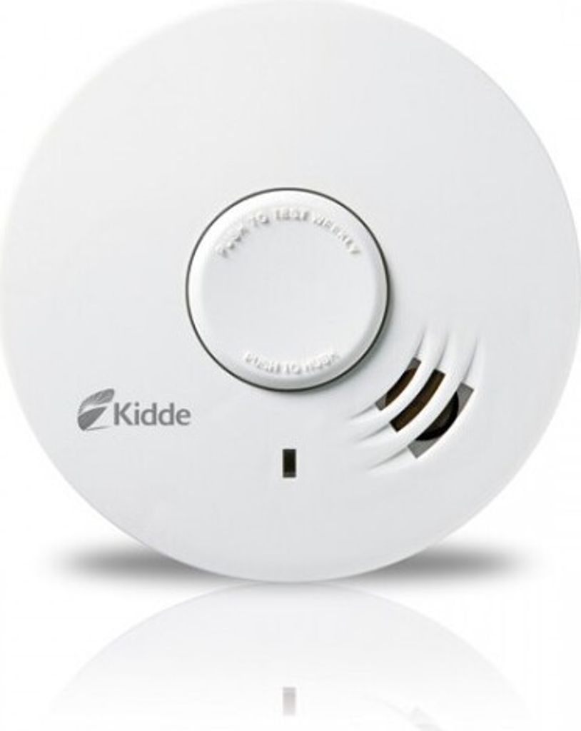 A white smoke detector is shown from a top-down perspective against a white background.