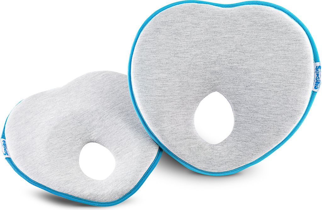 Two heart-shaped baby pillows with a hole in the center, placed on a white background.